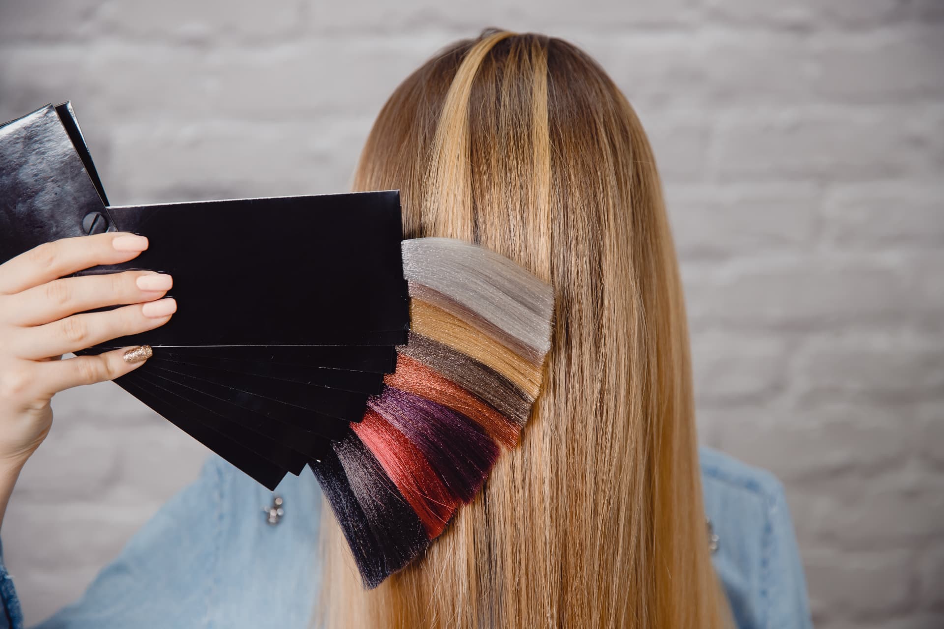 Shade fan held against a client's lengths to confirm a colour match in daylight