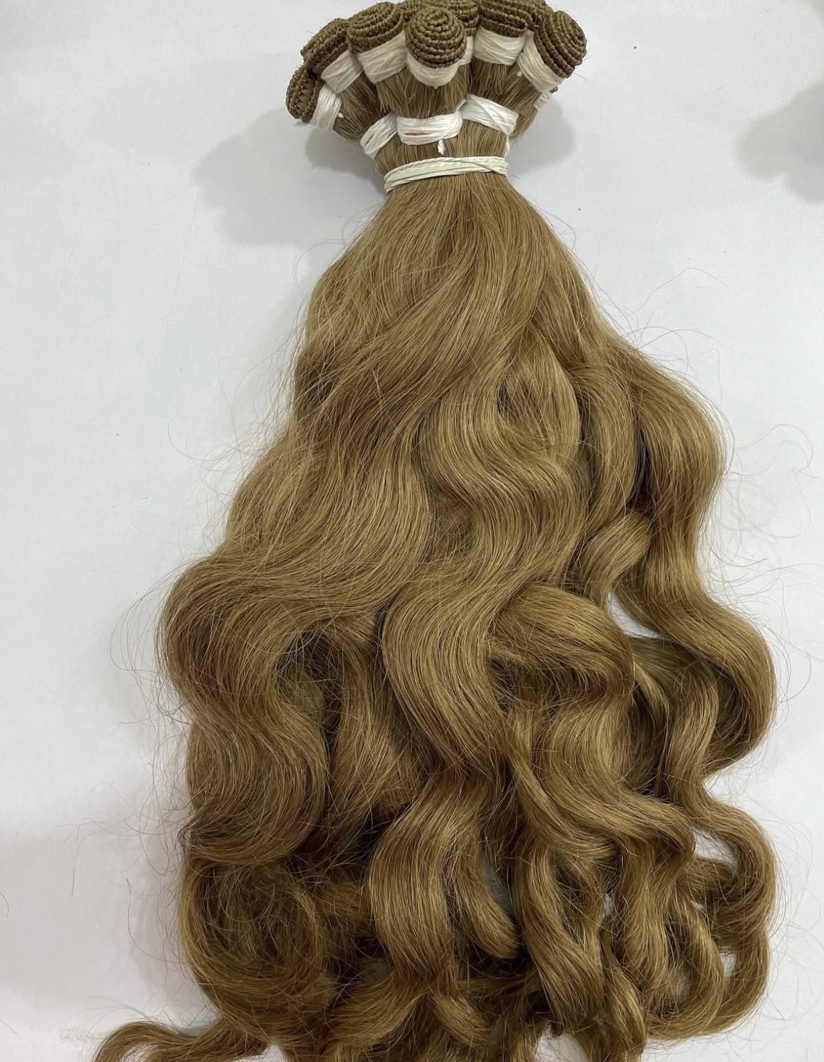 Finished hand-tied bundle in natural wave, photographed before dispatch