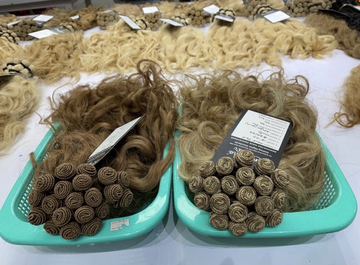 Two tagged K-Tip batches on the production table with blonde bulk lots behind