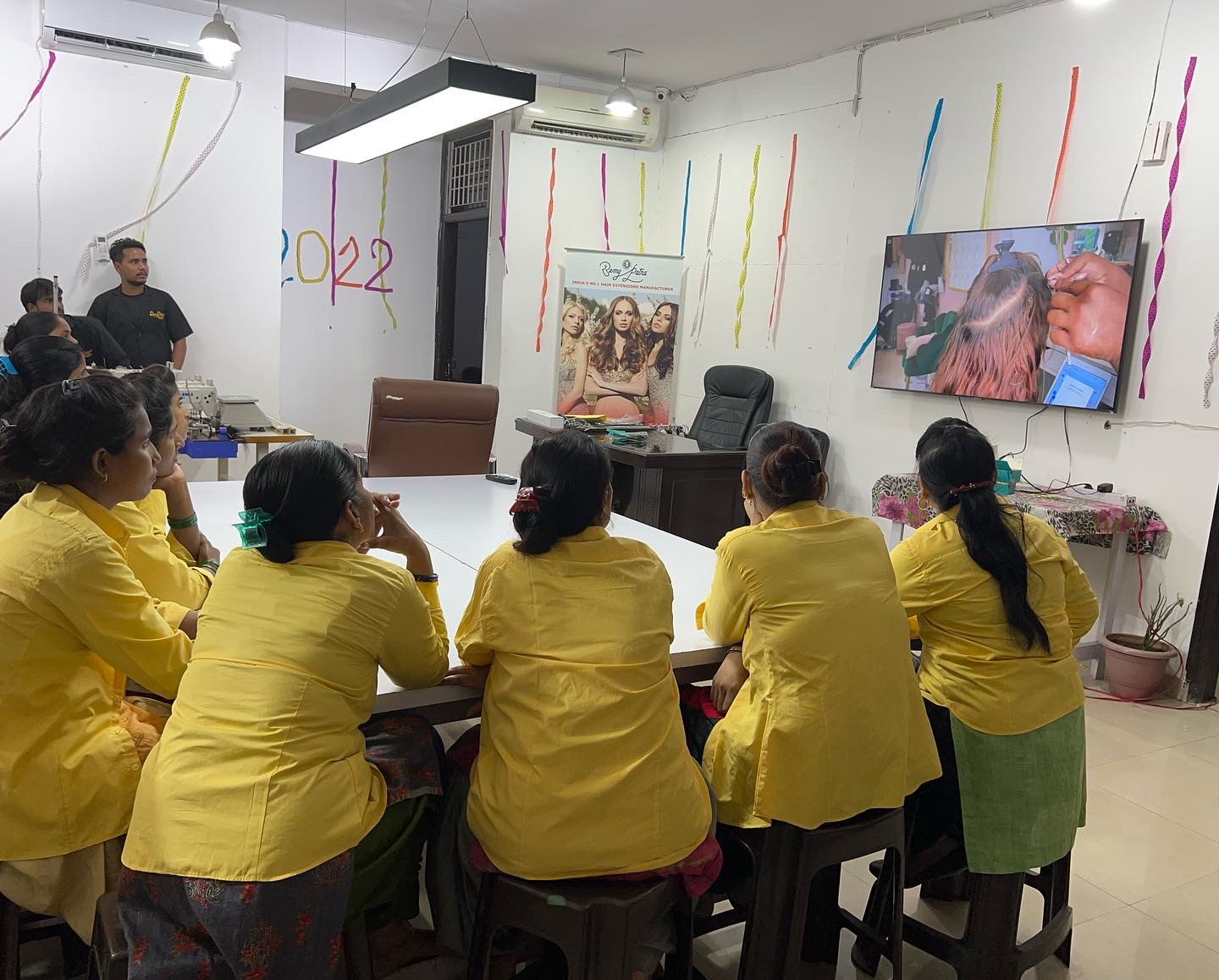 Factory team seated for a colour and installation technique training in the RemyPatra workroom