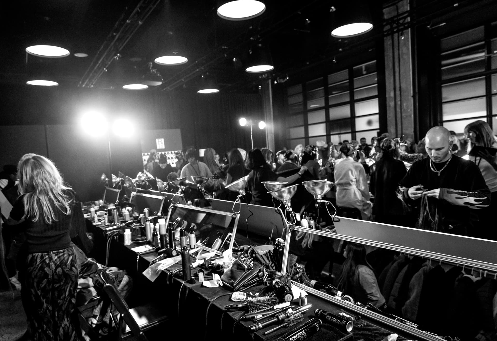 Backstage tool tables under work lamps during show preparation