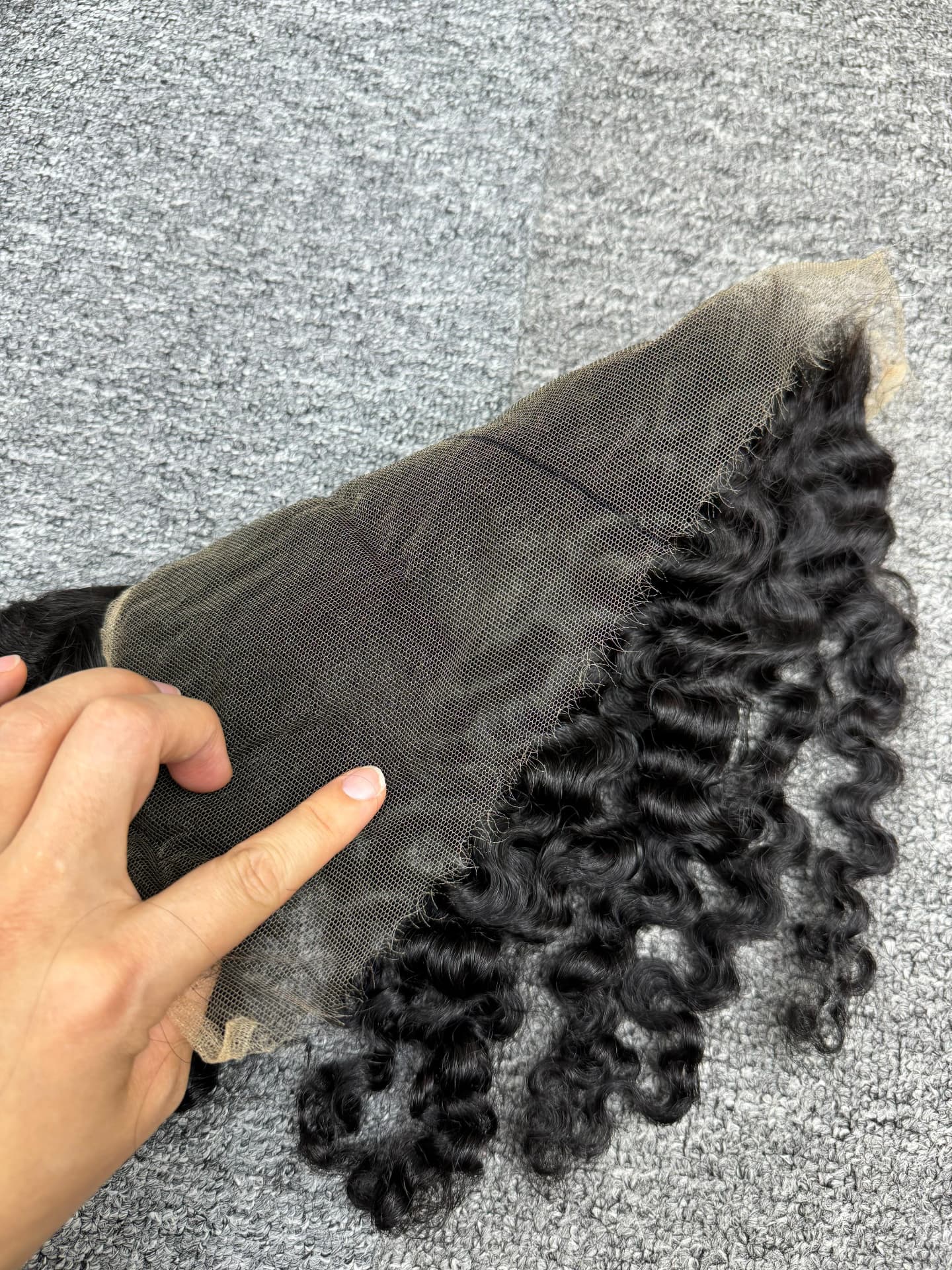 HD lace frontal held open to show the knotting and hairline density