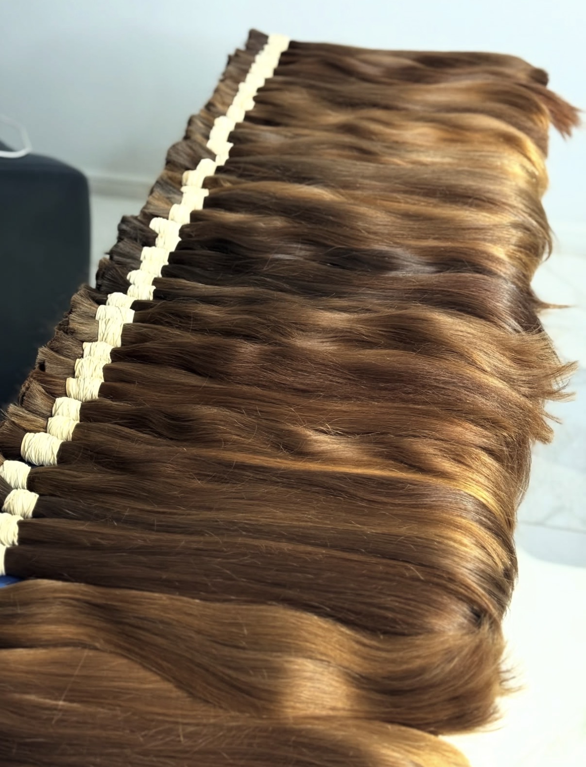 Close view of aligned single drawn brown hair showing natural sun-lifted mid-lengths