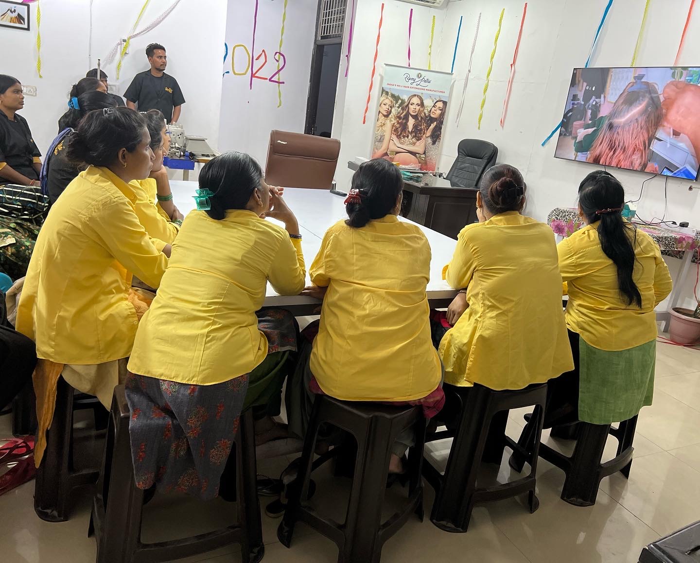RemyPatra team watching a technique demonstration on screen during a training session