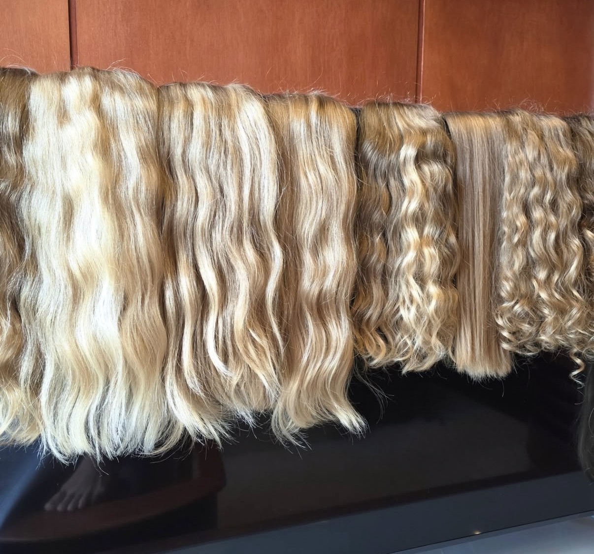 Naturally wavy virgin hair bundles showing the range within light European tones