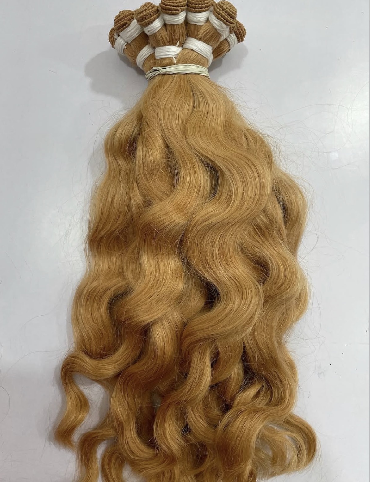 Hand-tied blonde wefts tied off and ready for the tag