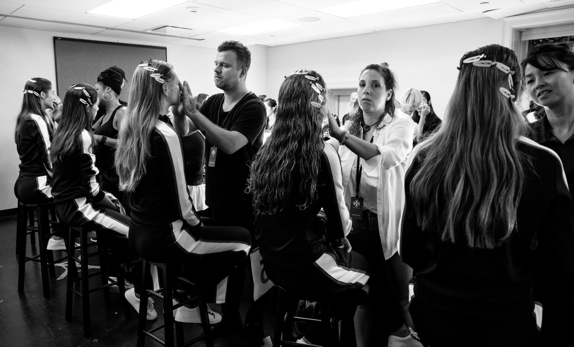 Backstage room of stylists working on long hair before a show