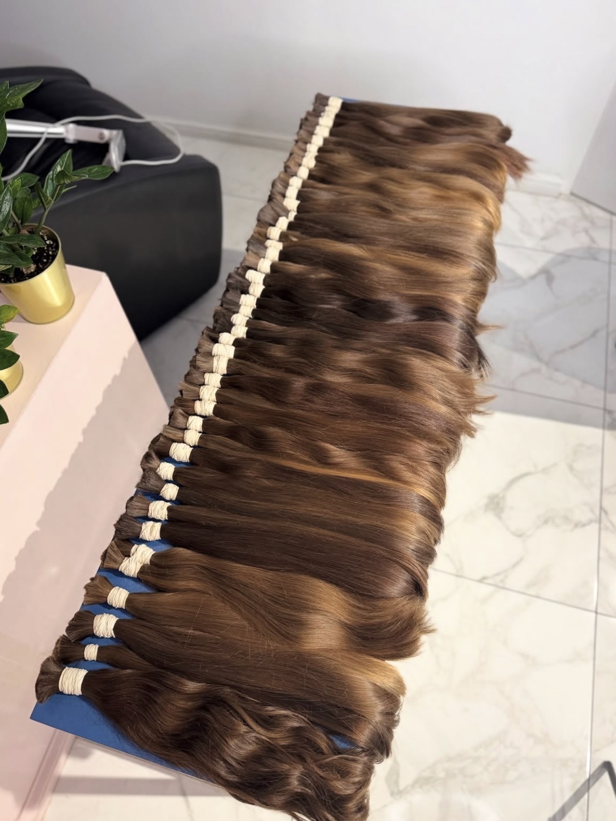 Long single drawn brown virgin ponytails tied and stacked ready for weighing