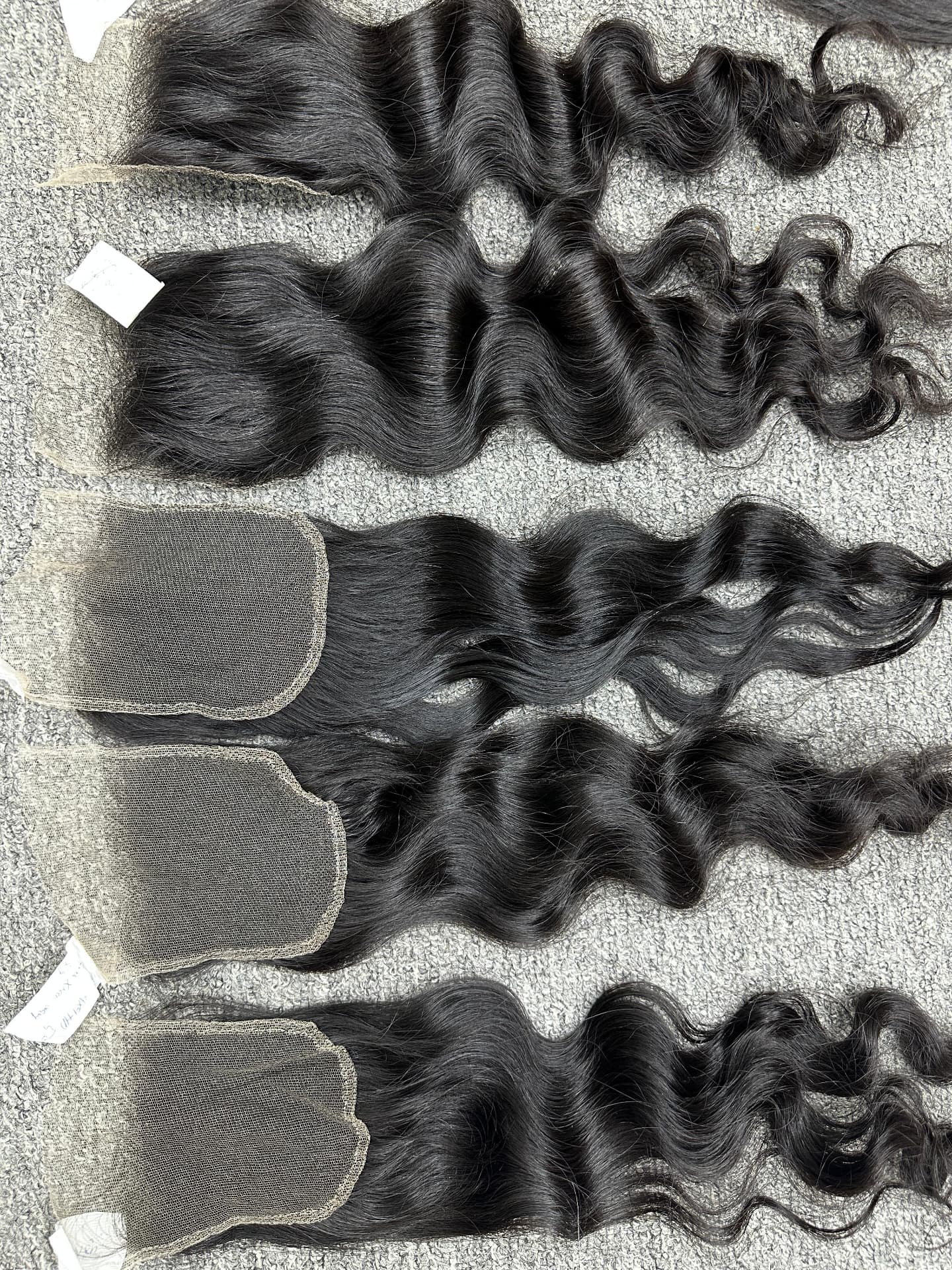 Wavy lace closures laid in a line for texture matching