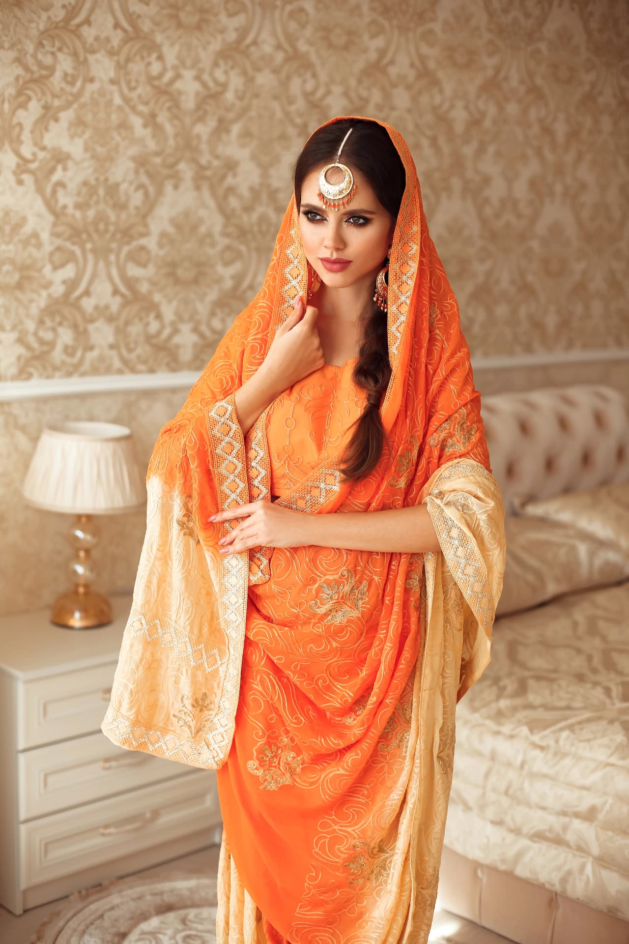 The orange saree — the colour of the temple, of devotion, of where this hair begins