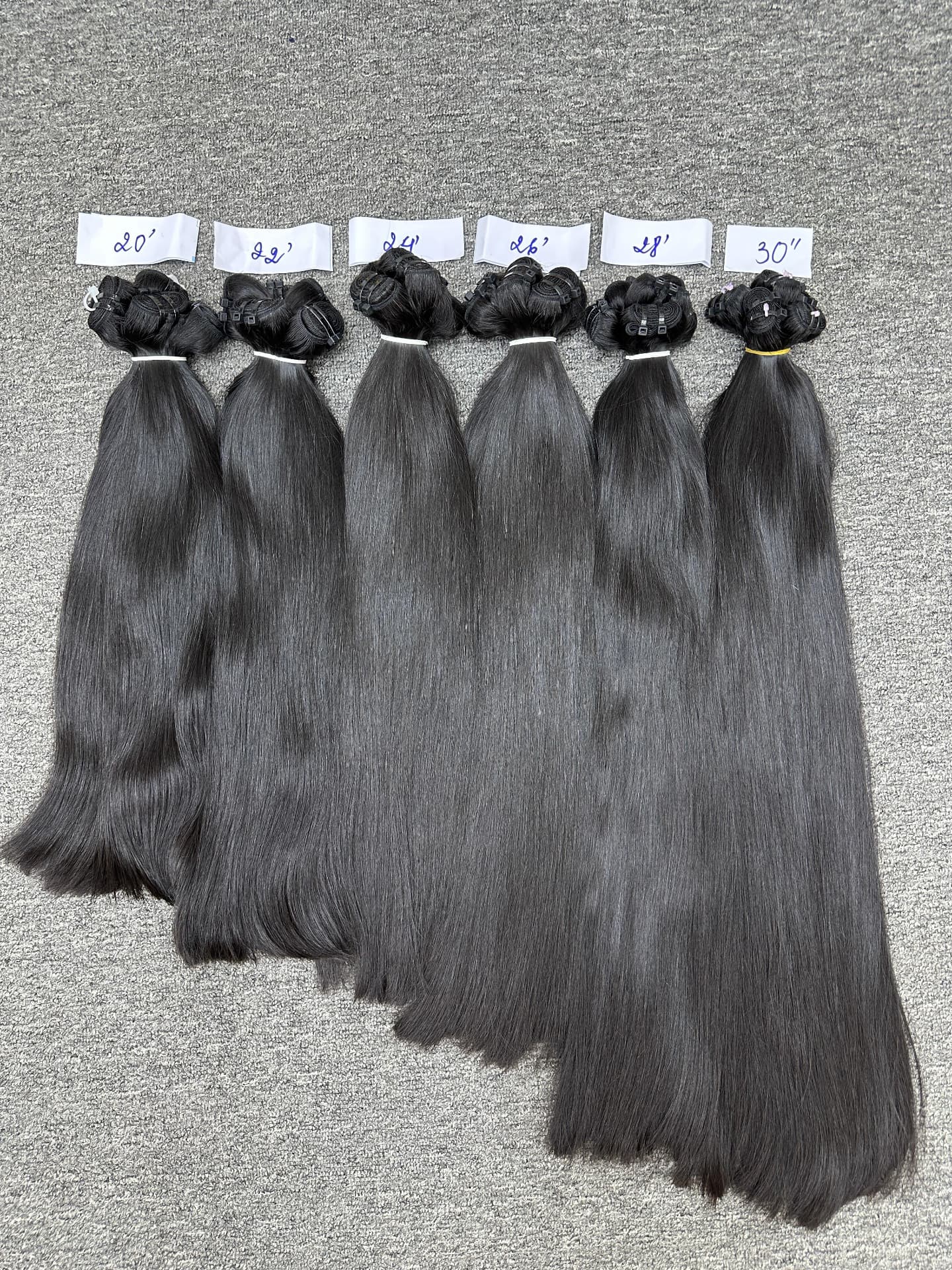 Straight temple hair graded from 20 inch to 30 inch with written length tags