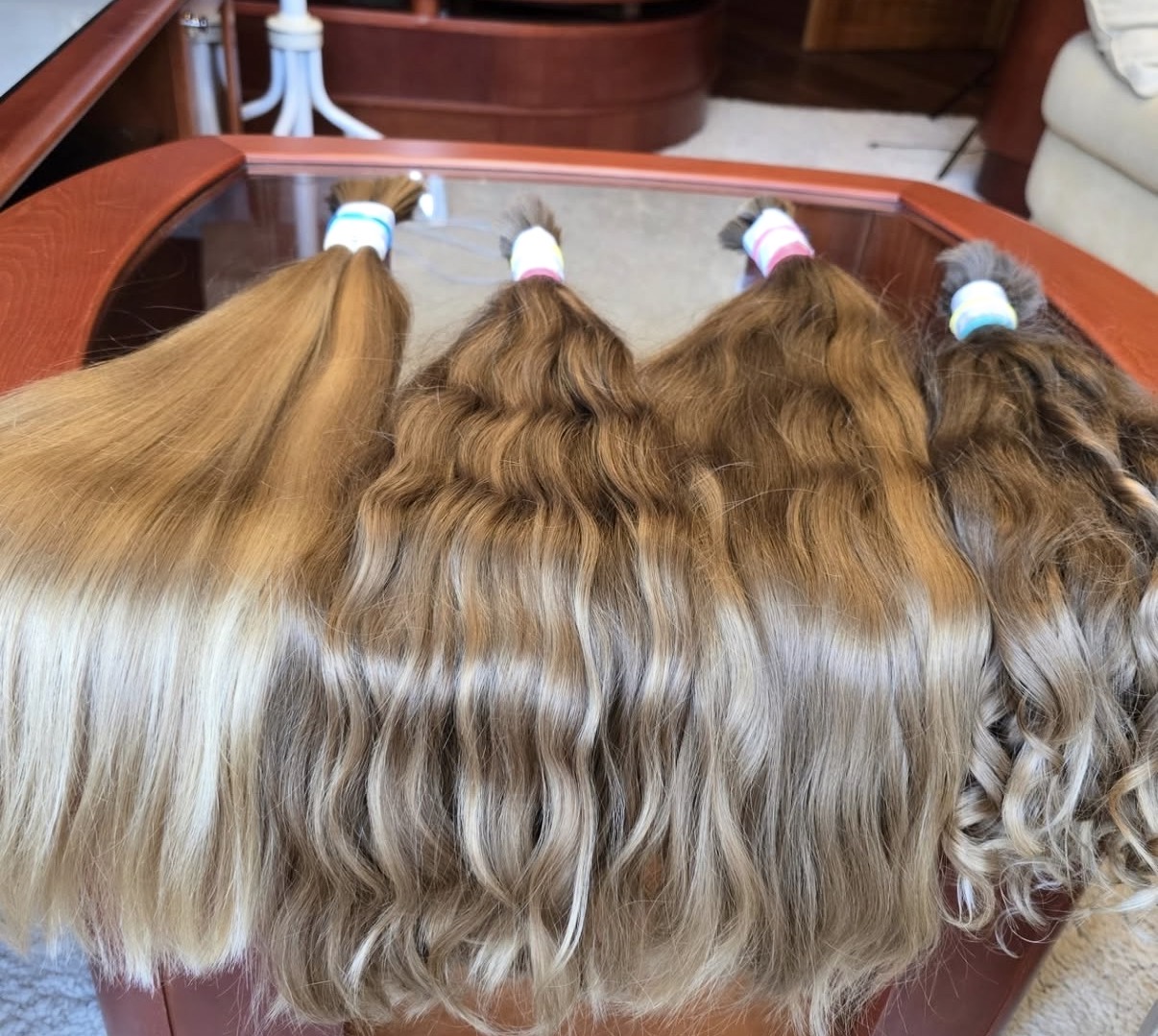 Four genuine virgin hair ponytails in naturally occurring dark blonde and brown tones