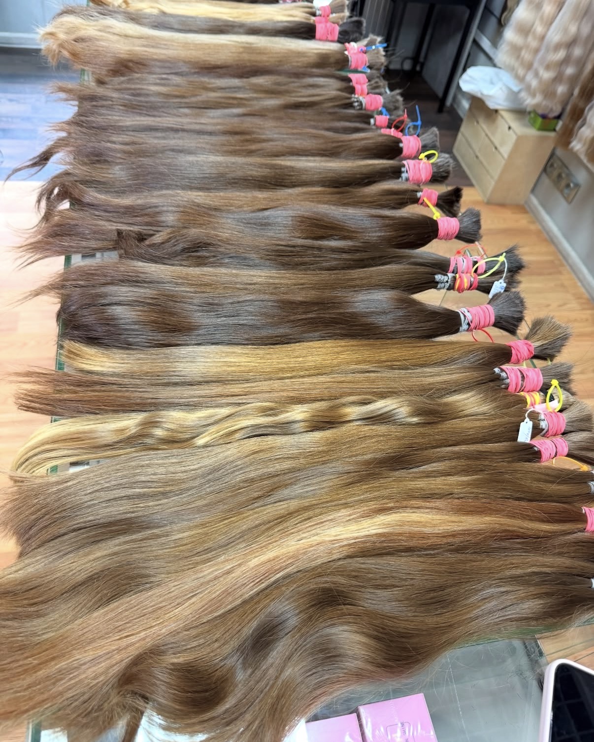 Large collection of individually tied virgin hair ponytails before manufacture