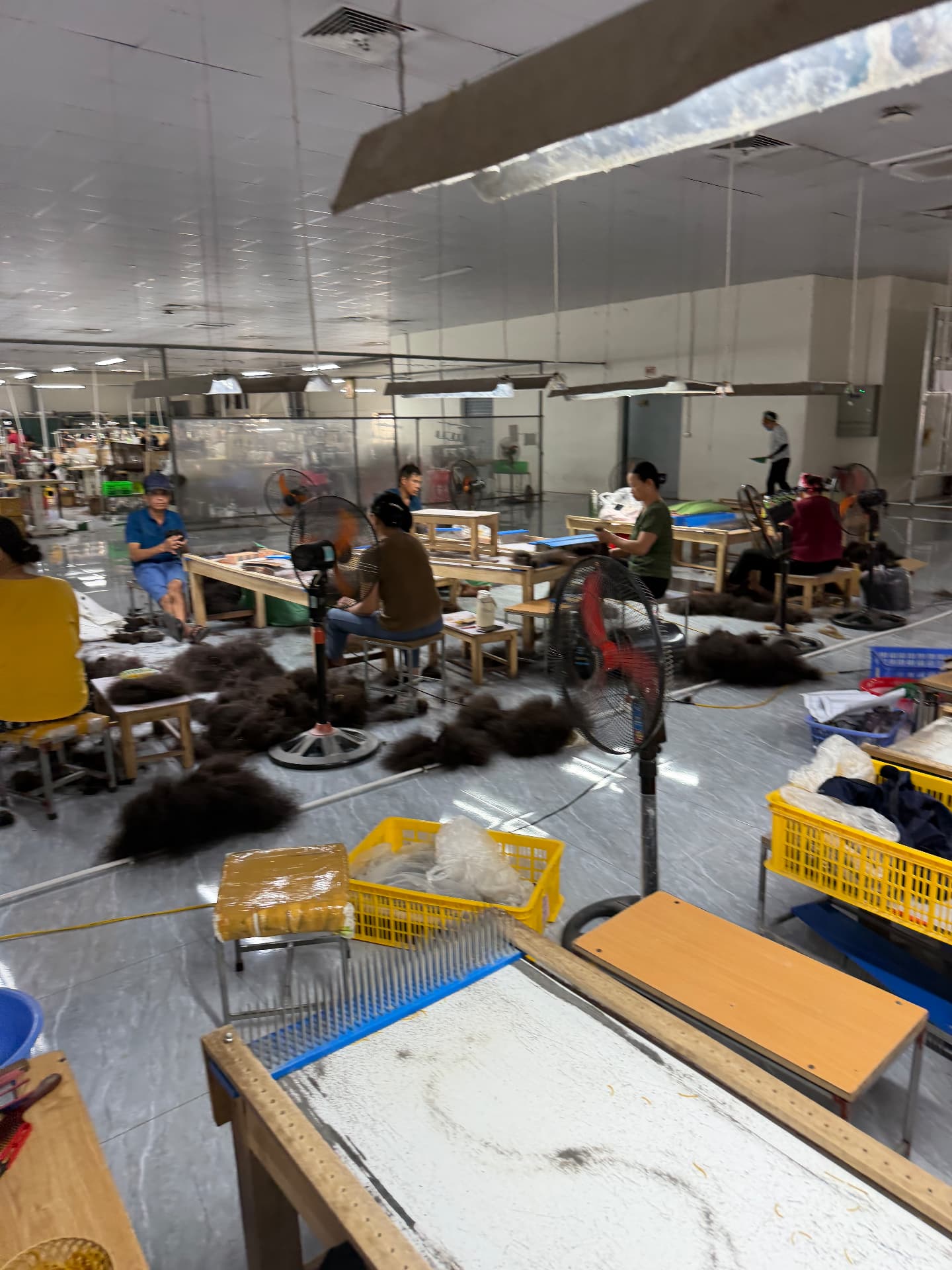 Hair lots arranged around the preparation tables inside the RemyPatra Manipur factory